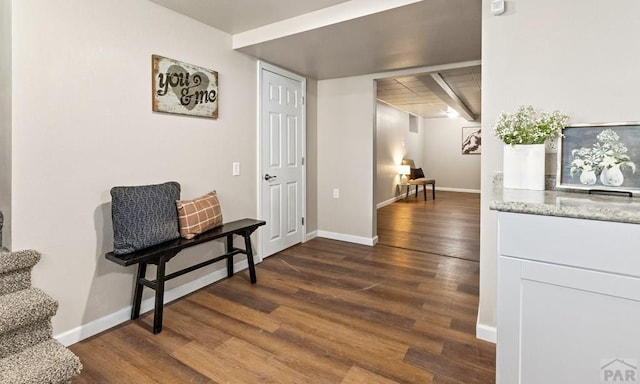 interior space featuring dark wood finished floors, stairway, and baseboards