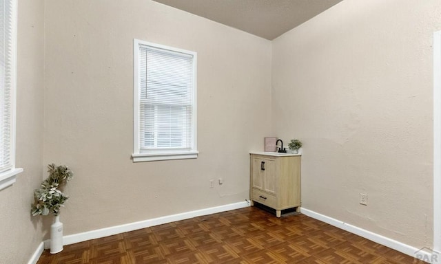 unfurnished room featuring baseboards