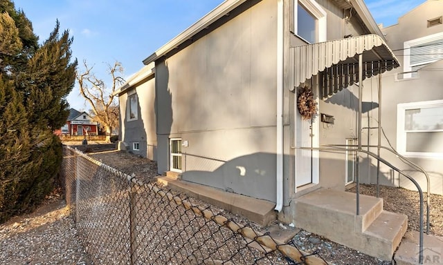 view of side of home with fence