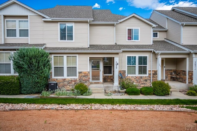 7639 Sandy Springs Pt, Fountain, CO 80817 - view of front of home featuring roof with shingles, stone siding, and central AC unit