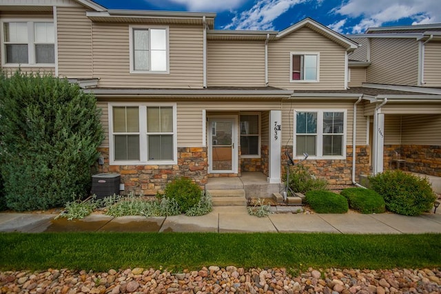 7639 Sandy Springs Pt, Fountain, CO 80817 - view of property featuring stone siding and cooling unit