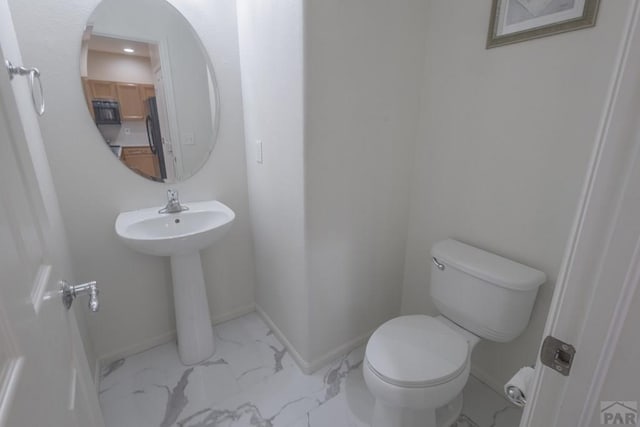 7639 Sandy Springs Pt, Fountain, CO 80817 - bathroom with marble finish flooring, toilet, baseboards, and a sink