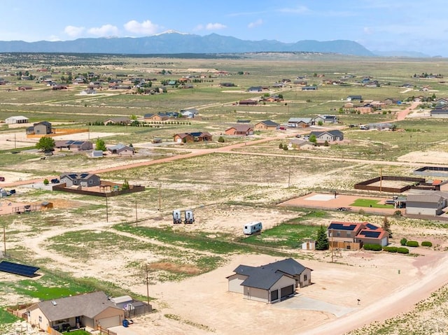 birds eye view of property with a rural view and a mountain view