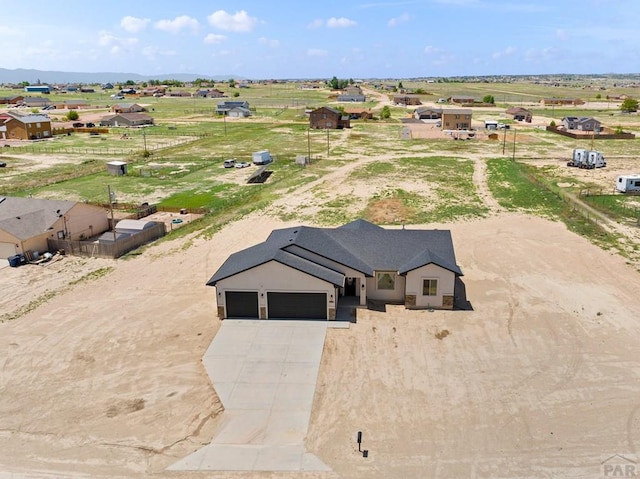 birds eye view of property with a rural view