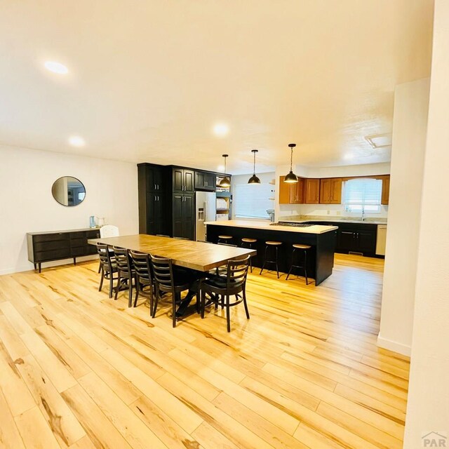 dining area featuring light wood-type flooring and recessed lighting