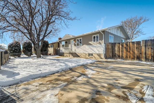 ranch-style home with fence