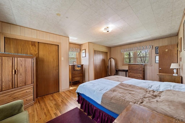 10511 Apache City Rd, Rye, CO 81069 - bedroom with wooden walls, wood finished floors, and multiple closets