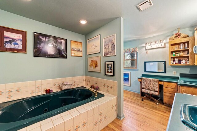 10511 Apache City Rd, Rye, CO 81069 - full bath with wood finished floors, a whirlpool tub, visible vents, vanity, and recessed lighting