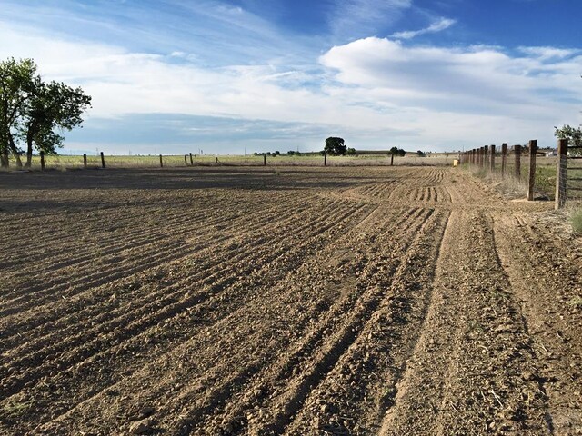 view of yard featuring a rural view and fence