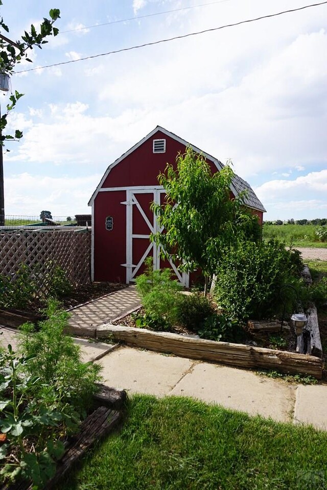 view of outbuilding featuring an outbuilding and fence