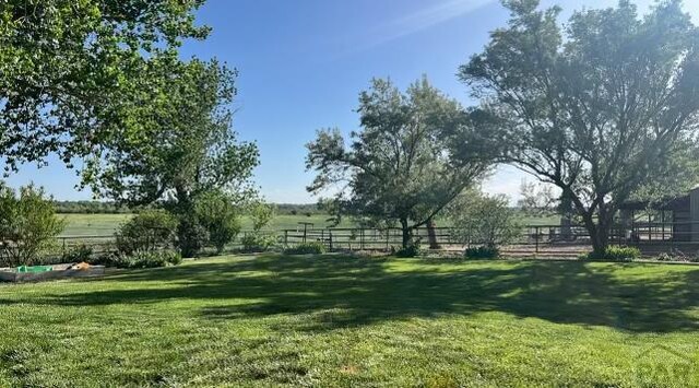 view of yard featuring a rural view and fence