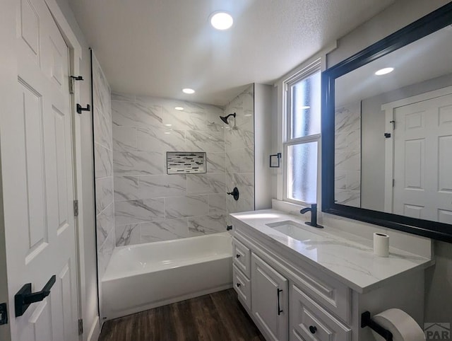 full bath with recessed lighting, shower / bath combination, vanity, and wood finished floors