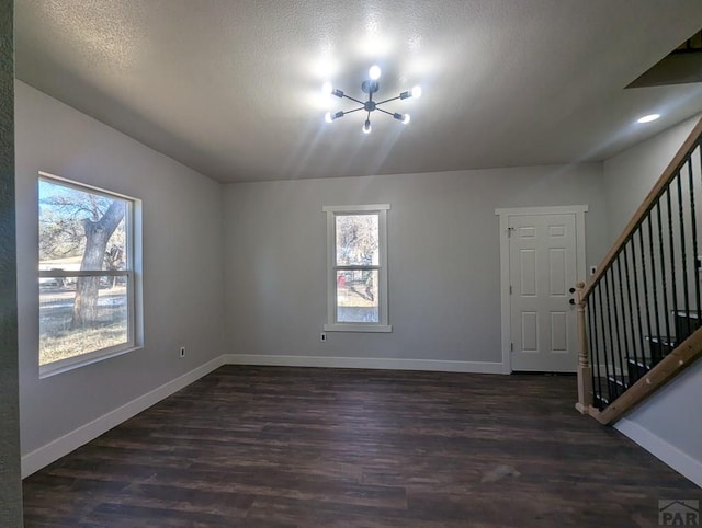 interior space with stairway, dark wood finished floors, and baseboards