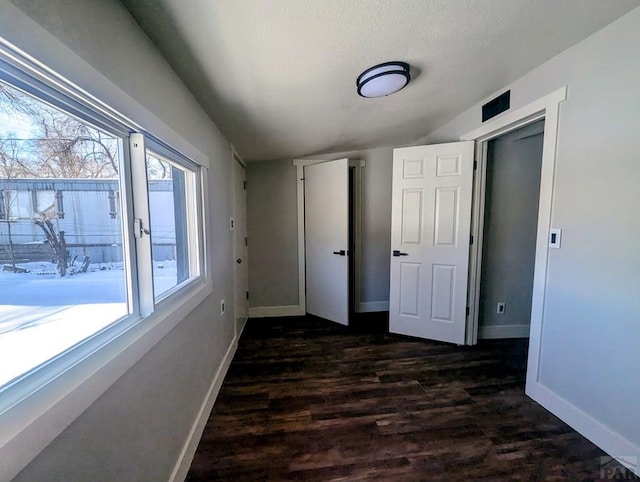 interior space featuring dark wood-style floors and baseboards