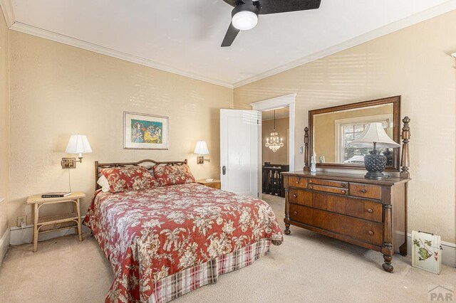 bedroom with crown molding, connected bathroom, a ceiling fan, and light colored carpet