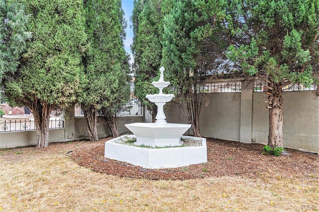 view of home's community featuring fence