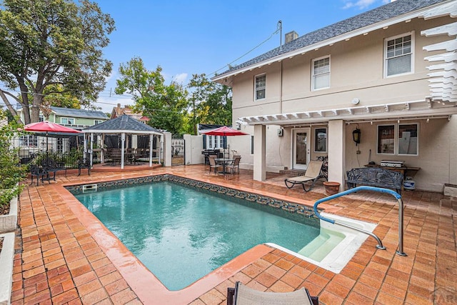 view of pool featuring a fenced in pool, fence, a gazebo, and a patio