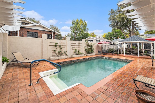 view of swimming pool featuring a gazebo, a patio area, a fenced backyard, and a fenced in pool