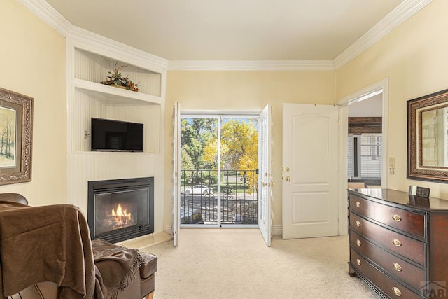 sitting room with crown molding, a large fireplace, light carpet, and plenty of natural light