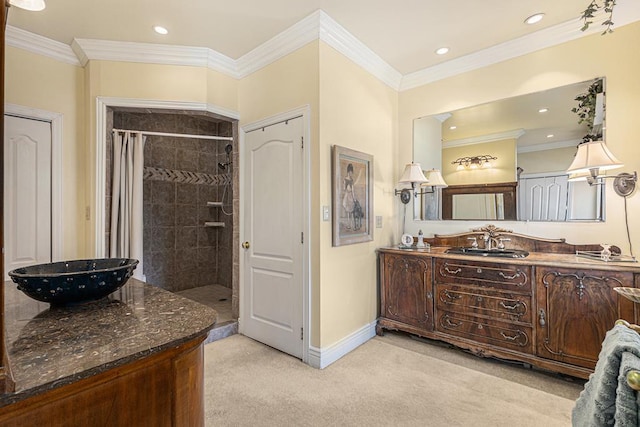 full bathroom with a closet, ornamental molding, a tile shower, vanity, and baseboards