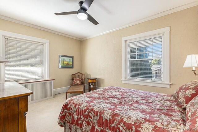 bedroom with radiator, multiple windows, ornamental molding, and light colored carpet