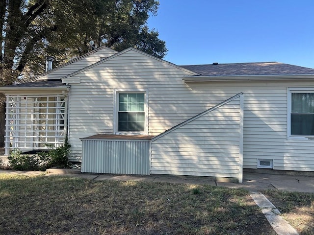 view of property exterior with a yard