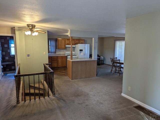 kitchen with carpet floors, white appliances, light countertops, ventilation hood, and brown cabinetry