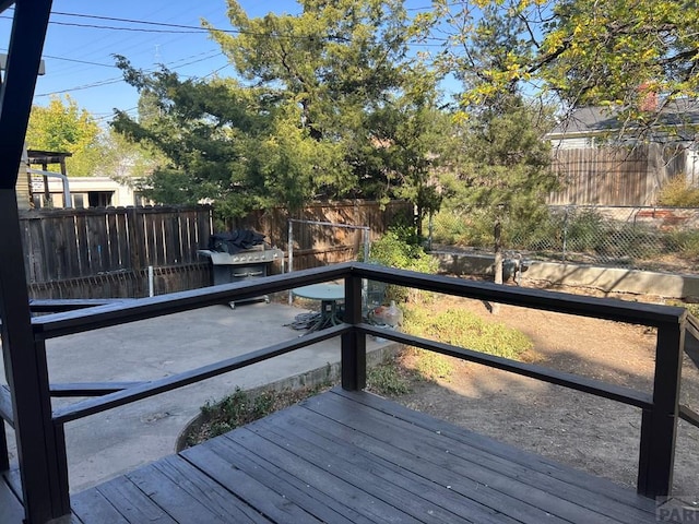 wooden deck with a fenced backyard