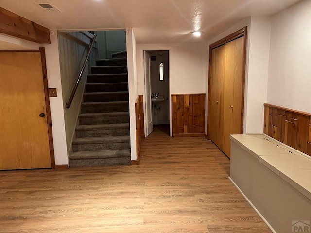 interior space with visible vents, wood finished floors, and wainscoting