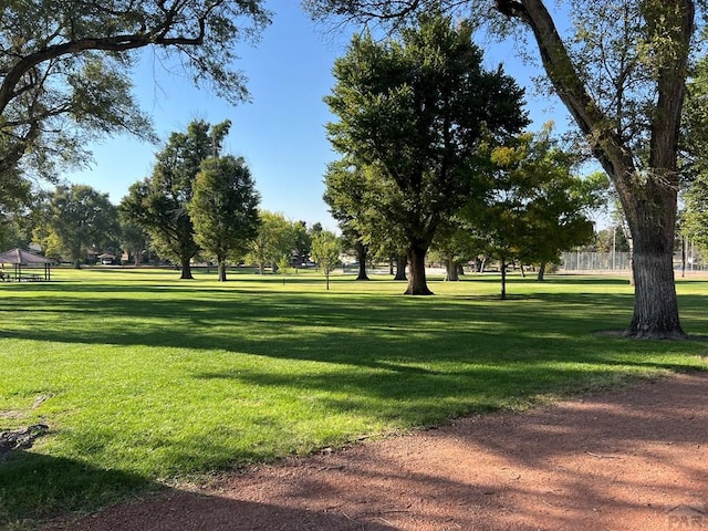 view of home's community with fence and a yard