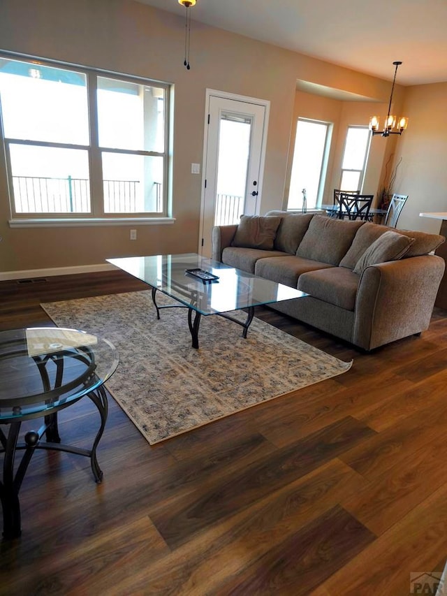 980 N Purcell Blvd, Pueblo West, CO 81007 - living room with dark wood-type flooring, a chandelier, and baseboards