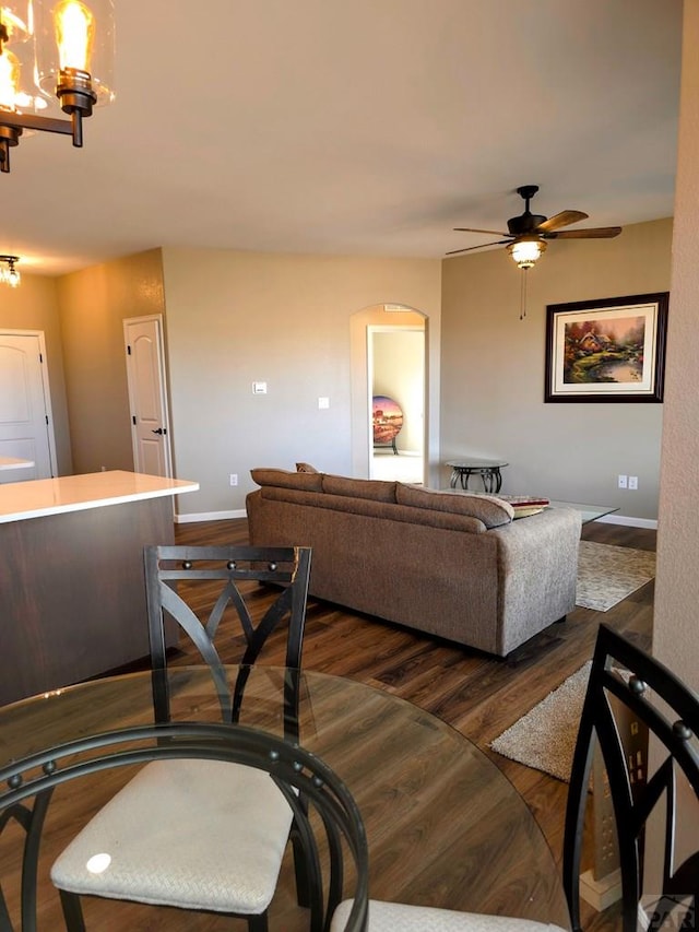 980 N Purcell Blvd, Pueblo West, CO 81007 - dining room featuring dark wood-type flooring, baseboards, and ceiling fan with notable chandelier