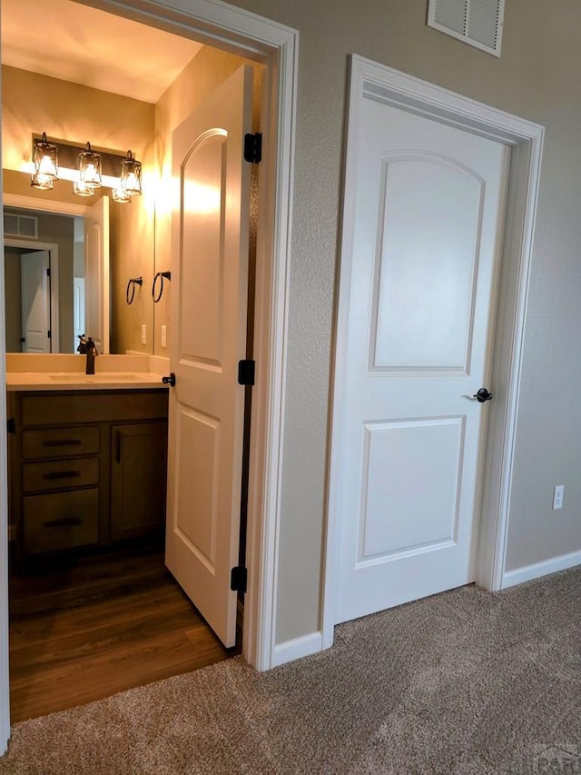 980 N Purcell Blvd, Pueblo West, CO 81007 - interior space featuring vanity, visible vents, baseboards, and carpet