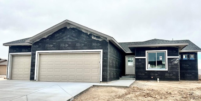 view of front of home with a garage and driveway