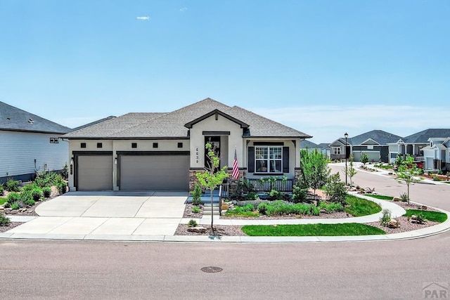 6639 Enclave Vista Loop, Colorado Springs, CO 80924 - view of front of property featuring stucco siding, an attached garage, concrete driveway, and a residential view