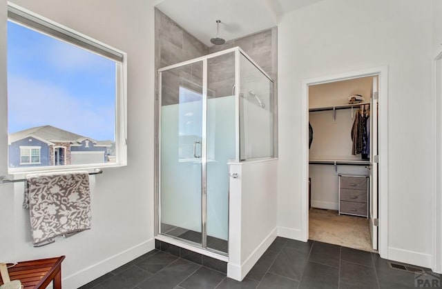 6639 Enclave Vista Loop, Colorado Springs, CO 80924 - full bathroom featuring a shower stall, tile patterned flooring, and a spacious closet