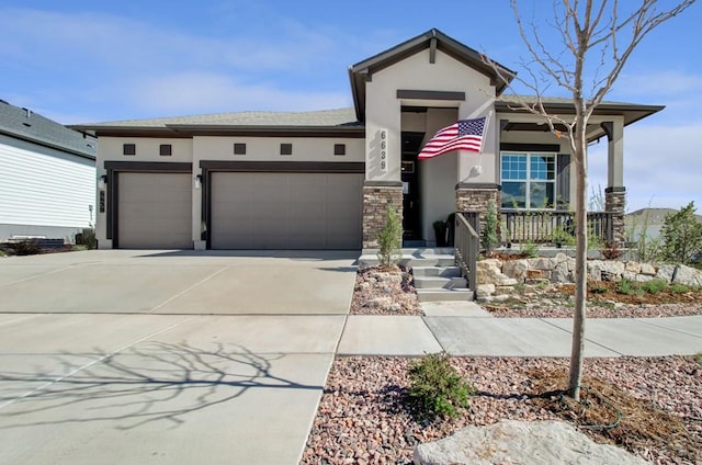 6639 Enclave Vista Loop, Colorado Springs, CO 80924 - view of front of home with stucco siding, a garage, covered porch, concrete driveway, and stone siding