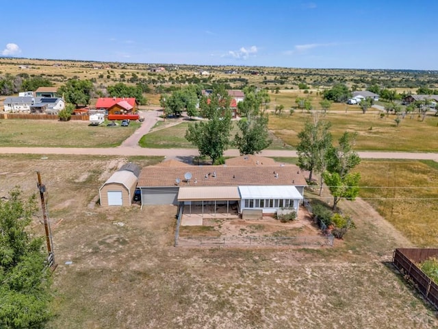 birds eye view of property with a rural view