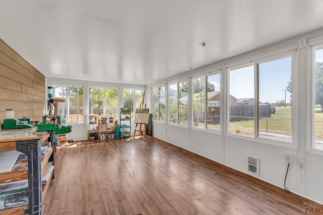 unfurnished sunroom with visible vents