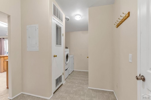 laundry room featuring laundry area, electric panel, baseboards, visible vents, and washing machine and clothes dryer