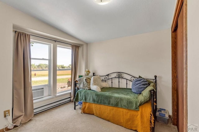 bedroom featuring a baseboard heating unit, lofted ceiling, and carpet flooring