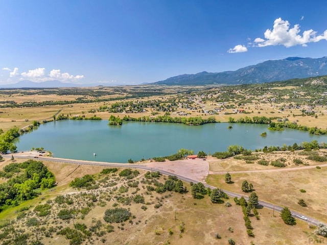 birds eye view of property with a water and mountain view