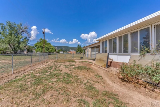 view of yard with fence and a mountain view