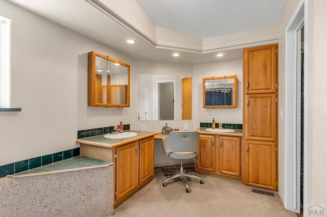 full bath with visible vents, two vanities, a sink, and recessed lighting