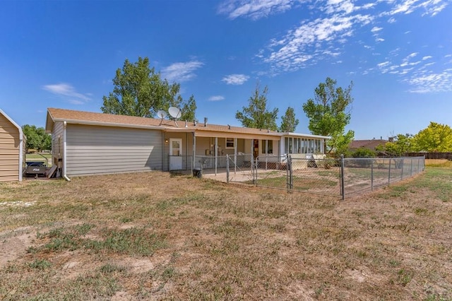 back of property with fence and a lawn