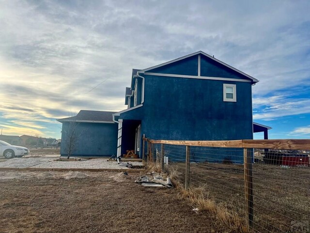 view of side of property with fence