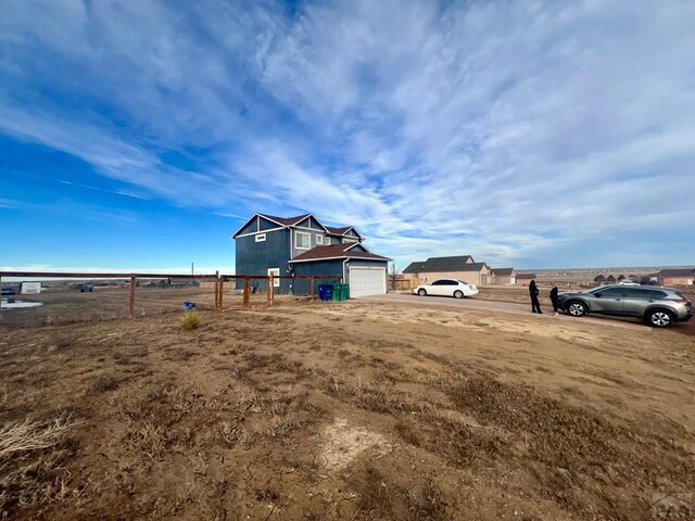 view of yard featuring a garage and fence