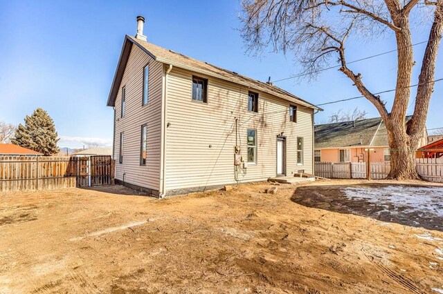 back of house featuring fence