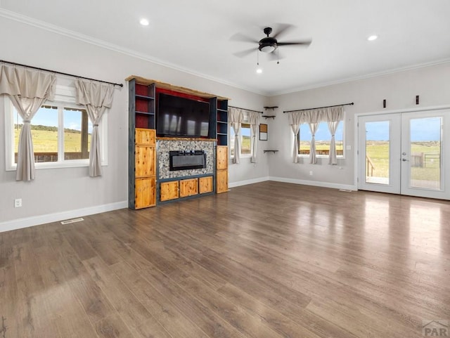 unfurnished living room featuring crown molding and dark wood-style flooring