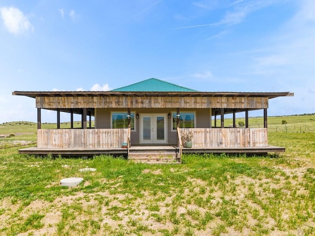 back of property with metal roof and french doors